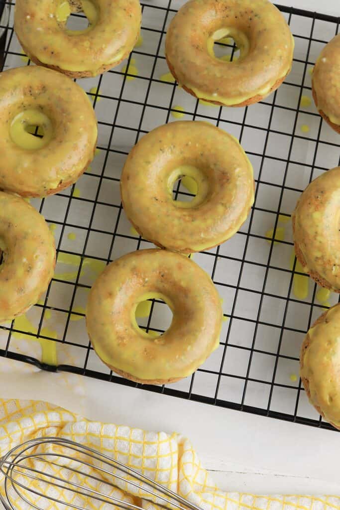 yummy lemon poppyseed donuts glazed cooling on the rack
